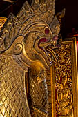 Wat Xieng Thong temple in Luang Prabang, Laos. Detail of flame-like gilded lacquered carvings of sacred serpents or nagas on the Royal Funerary Chariot. 